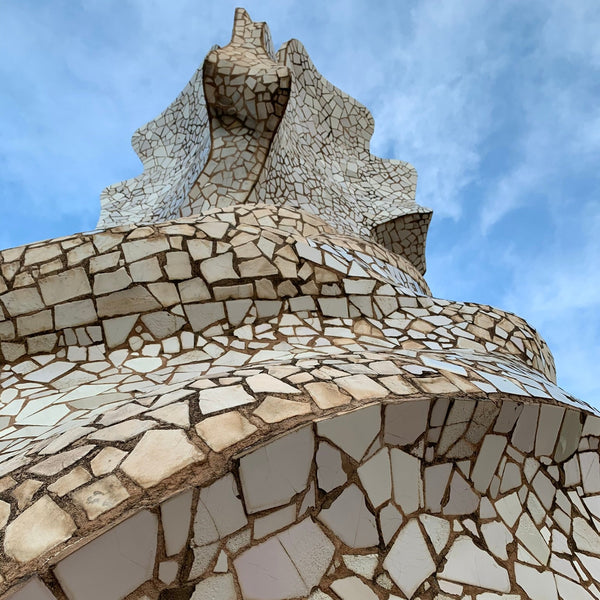 Mosaic-patterned structure against a blue sky