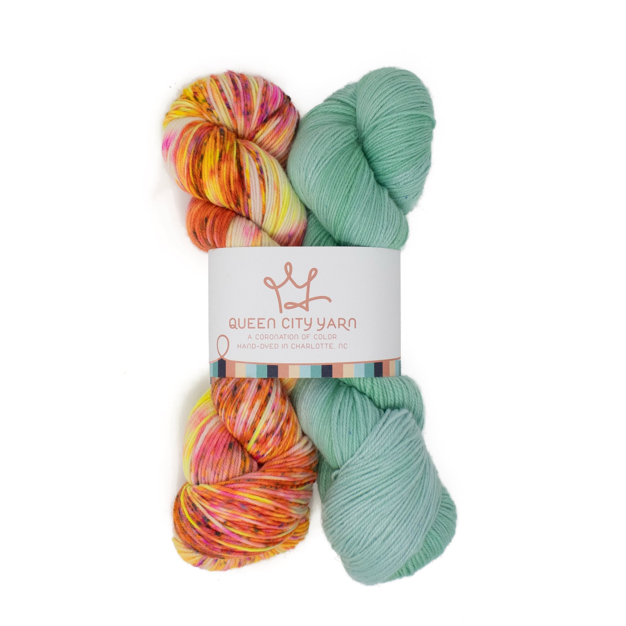 Two skeins of colorful yarn with a 'Queen City Yarn' label on a white background